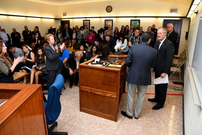 Photograph of a large crowd of people gathered in the Madera City Hall Council Chambers